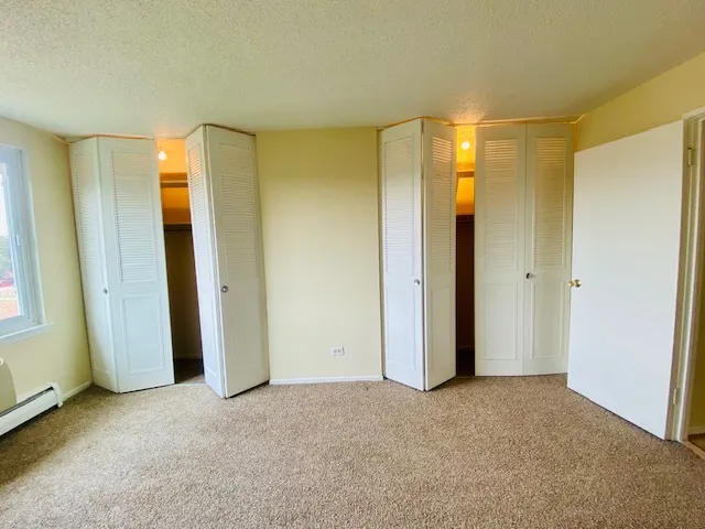 a view of a bathroom with closet and mirror