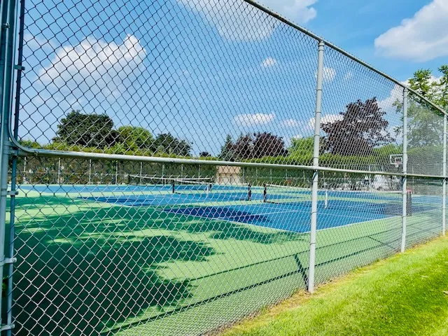 a view of a yard with a wooden fence