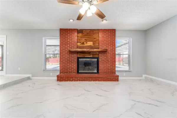 a kitchen with stainless steel appliances kitchen island granite countertop a refrigerator a stove a microwave oven with a dining table and chairs