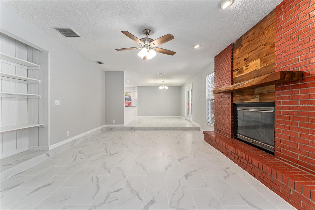5041 Northeast 4th Street Ocala, FL 34470 - Photo 16 of 70 a view of an empty room with a fireplace and a window