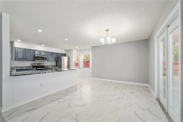 a kitchen with stainless steel appliances granite countertop a sink and a stove