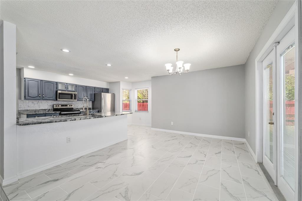 5041 Northeast 4th Street Ocala, FL 34470 - Photo 18 of 70 a view of kitchen with kitchen island stainless steel appliances refrigerator stove microwave and cabinets