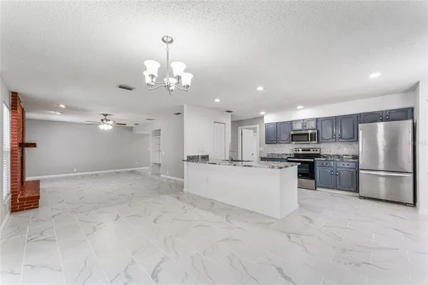 a kitchen with stainless steel appliances granite countertop a sink and a stove
