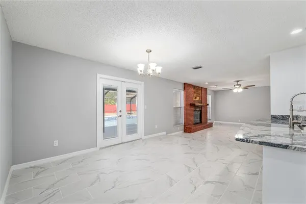 a kitchen with stainless steel appliances kitchen island granite countertop a stove and a sink