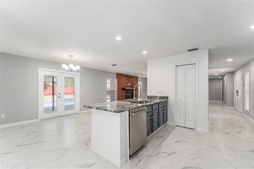 5041 Northeast 4th Street Ocala, FL 34470 - Photo 25 of 70 a kitchen with stainless steel appliances granite countertop a sink and a stove