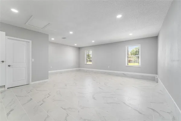 a bathroom with a granite countertop sink a toilet and shower
