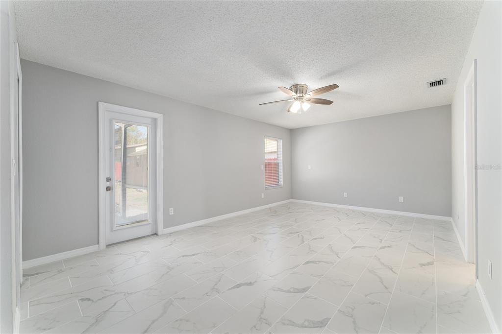 5041 Northeast 4th Street Ocala, FL 34470 - Photo 35 of 70 an empty room with windows and fan