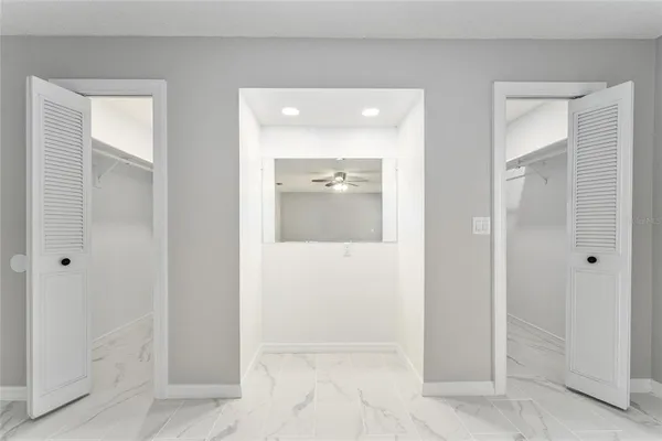 a bathroom with a granite countertop sink a toilet a mirror a bathtub and shower