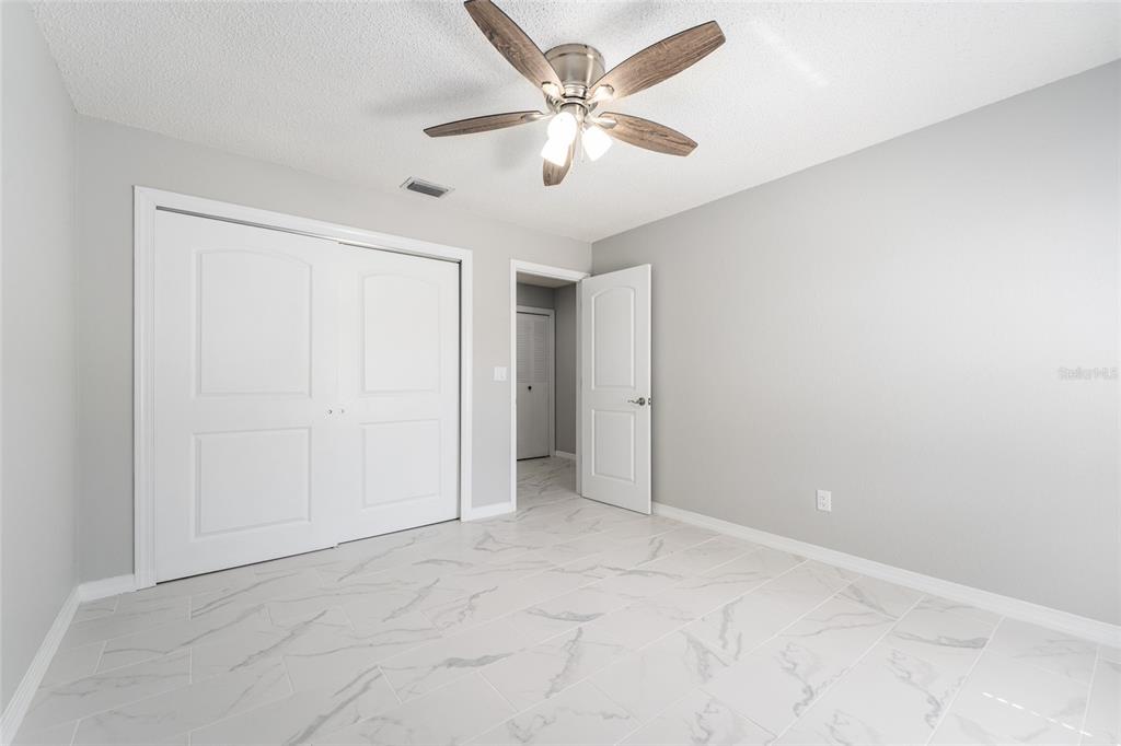 5041 Northeast 4th Street Ocala, FL 34470 - Photo 43 of 70 an empty room with closet and a ceiling fan