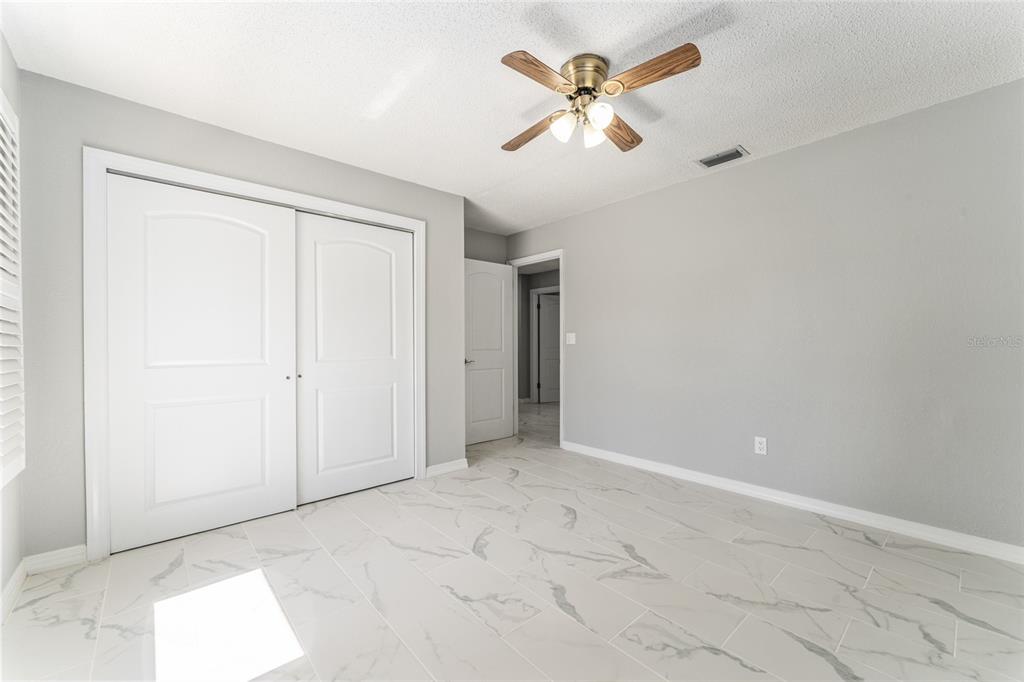 5041 Northeast 4th Street Ocala, FL 34470 - Photo 45 of 70 an empty room with closet and a chandelier fan