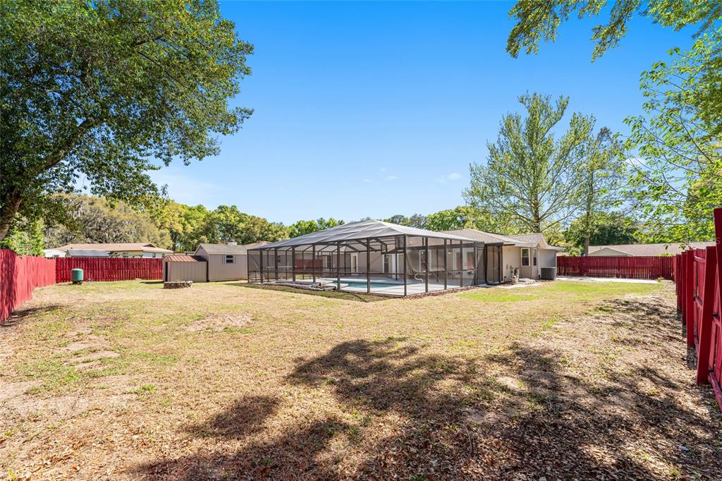5041 Northeast 4th Street Ocala, FL 34470 - Photo 57 of 70 a view of an house with backyard and trees