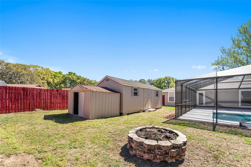 5041 Northeast 4th Street Ocala, FL 34470 - Photo 61 of 70 a view of a backyard with a small cabin