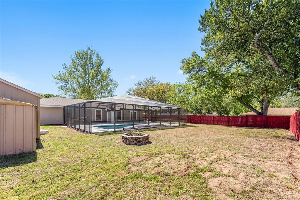 5041 Northeast 4th Street Ocala, FL 34470 - Photo 62 of 70 a house view with swimming pool and trees in the background