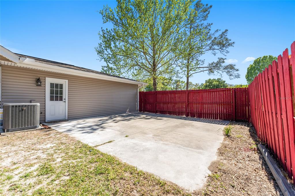 5041 Northeast 4th Street Ocala, FL 34470 - Photo 68 of 70 a view of backyard with wooden fence and large trees