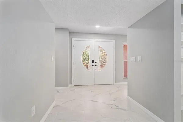 a view of fireplace and window in empty room