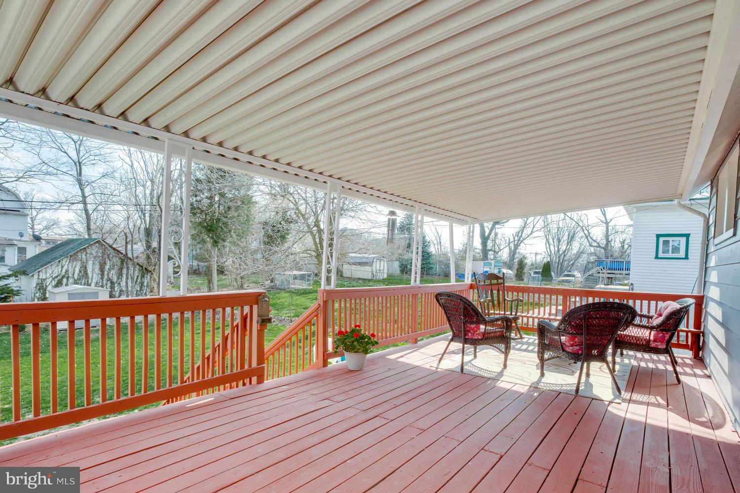 2403 East Cold Spring Lane Baltimore, MD 21214 - Photo 28 of 29 Covered rear deck with stairs to fully fenced yard