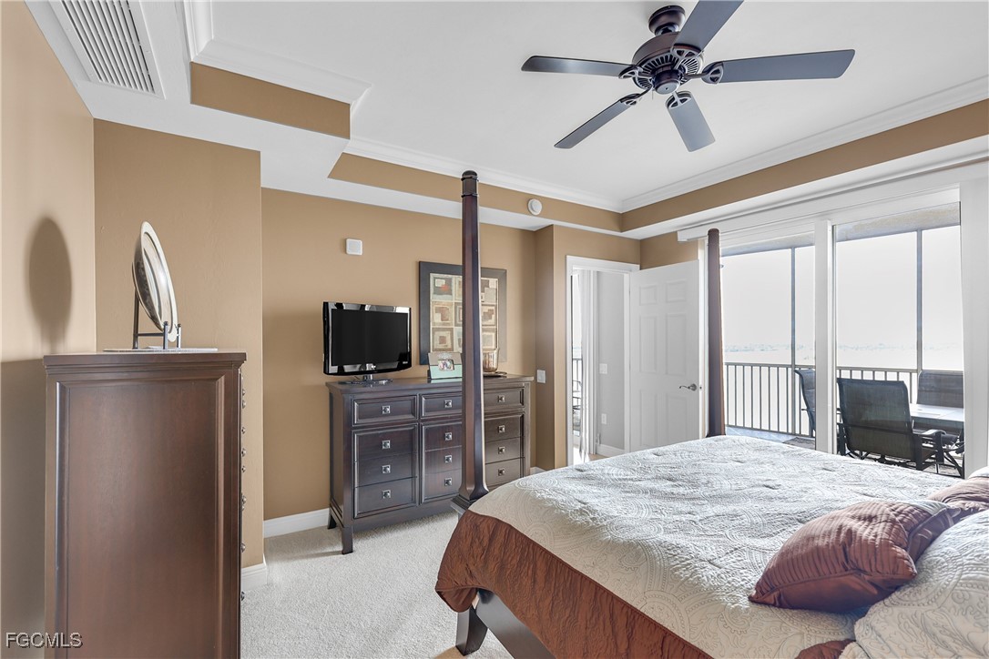 2743 First Street, Unit 1502 Fort Myers, FL 33916 - Photo 18 of 35 a bedroom with a bed a flat screen tv and a dresser