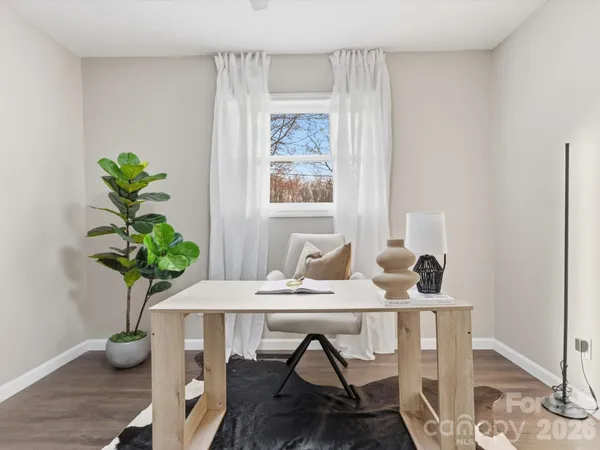 a view of a workspace with furniture and a potted plant