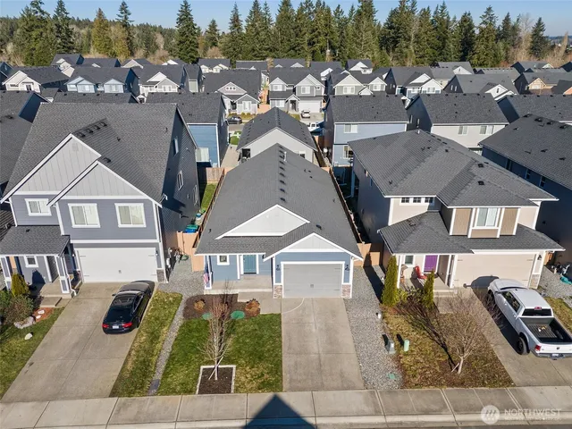 an aerial view of multiple houses with a yard