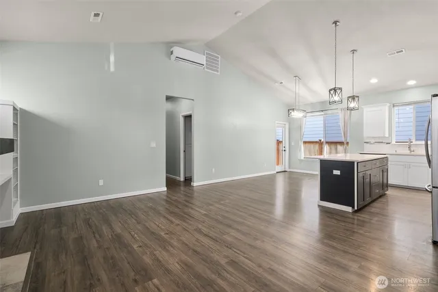 a view of large kitchen with a sink and wooden floor