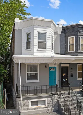 a view of a house with a wooden fence