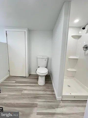 a bathroom with a glass shower door