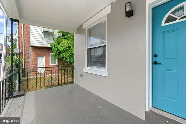 a view of kitchen with refrigerator and wooden floor