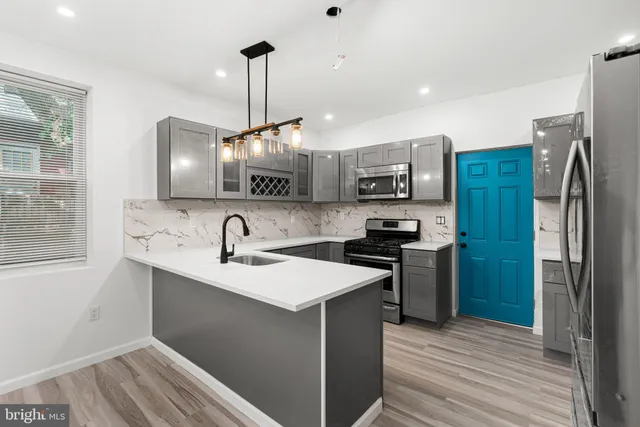 a kitchen with a sink stainless steel appliances and cabinets