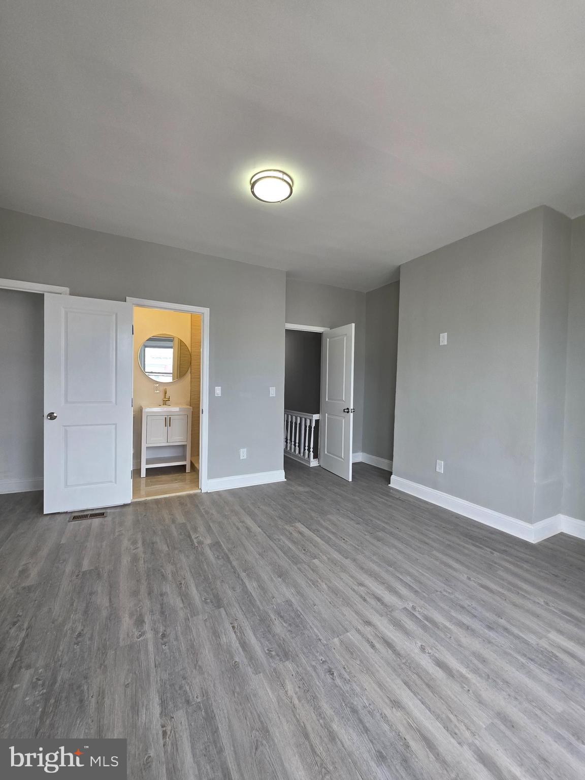 6026 Irving Street Philadelphia, PA 19139 - Photo 14 of 30 a view of an empty room with wooden floor and windows