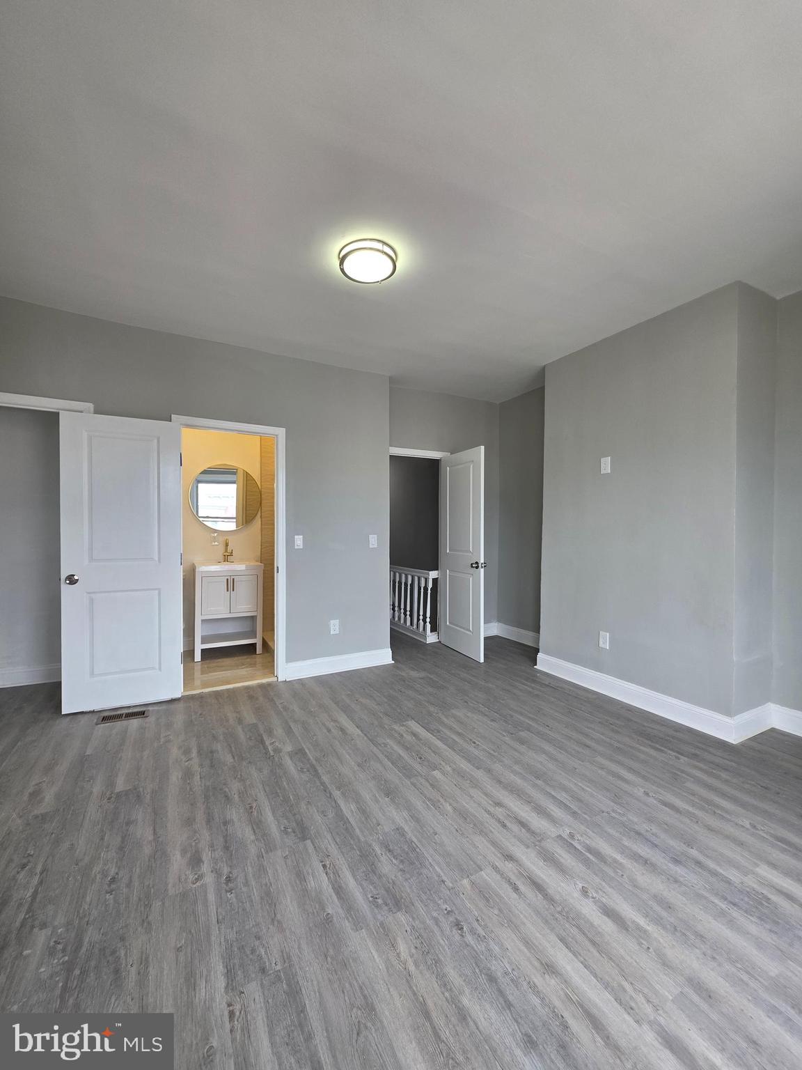 6026 Irving Street Philadelphia, PA 19139 - Photo 16 of 30 a view of an empty room with window and wooden floor