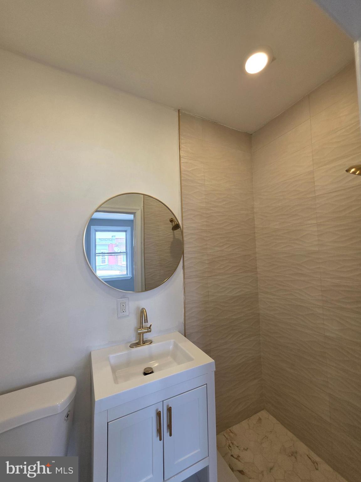 6026 Irving Street Philadelphia, PA 19139 - Photo 18 of 30 a bathroom with a toilet sink and mirror