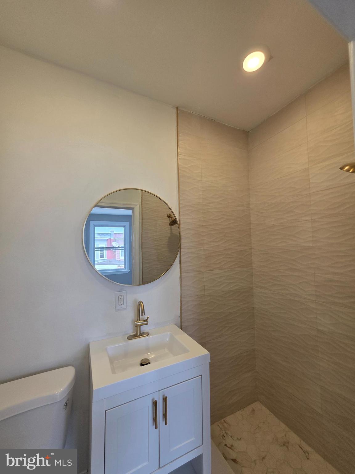 6026 Irving Street Philadelphia, PA 19139 - Photo 19 of 30 a bathroom with a toilet sink and mirror