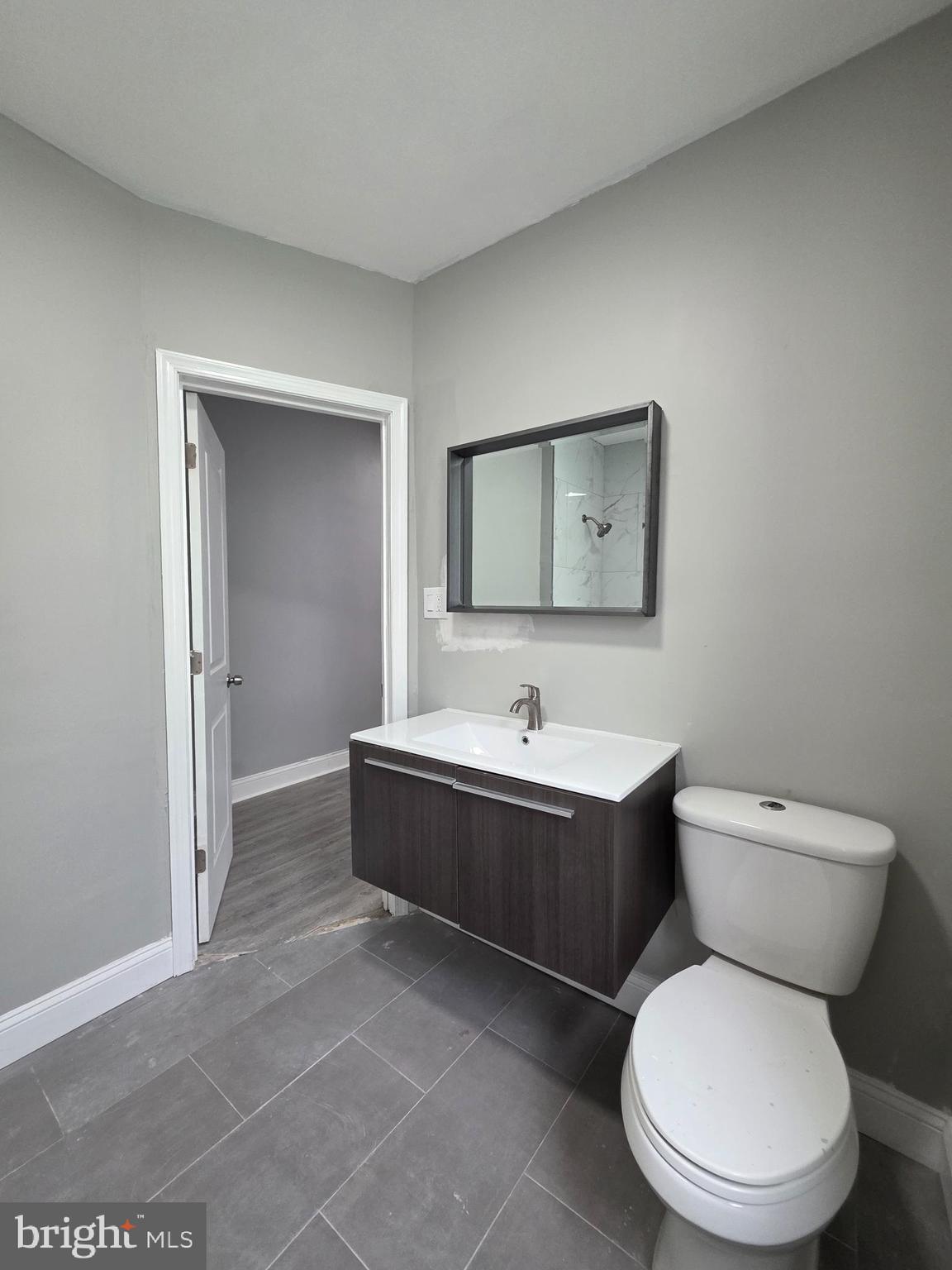 6026 Irving Street Philadelphia, PA 19139 - Photo 25 of 30 a bathroom with a toilet sink and mirror