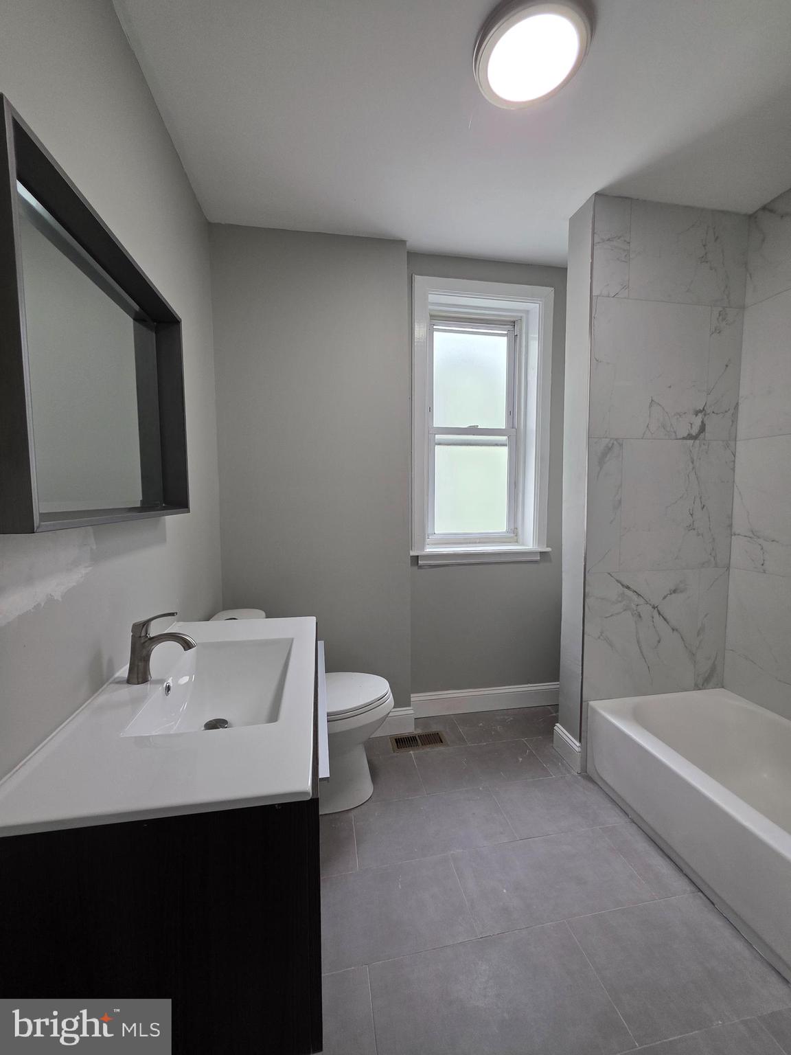 6026 Irving Street Philadelphia, PA 19139 - Photo 27 of 30 a bathroom with a sink a toilet and shower