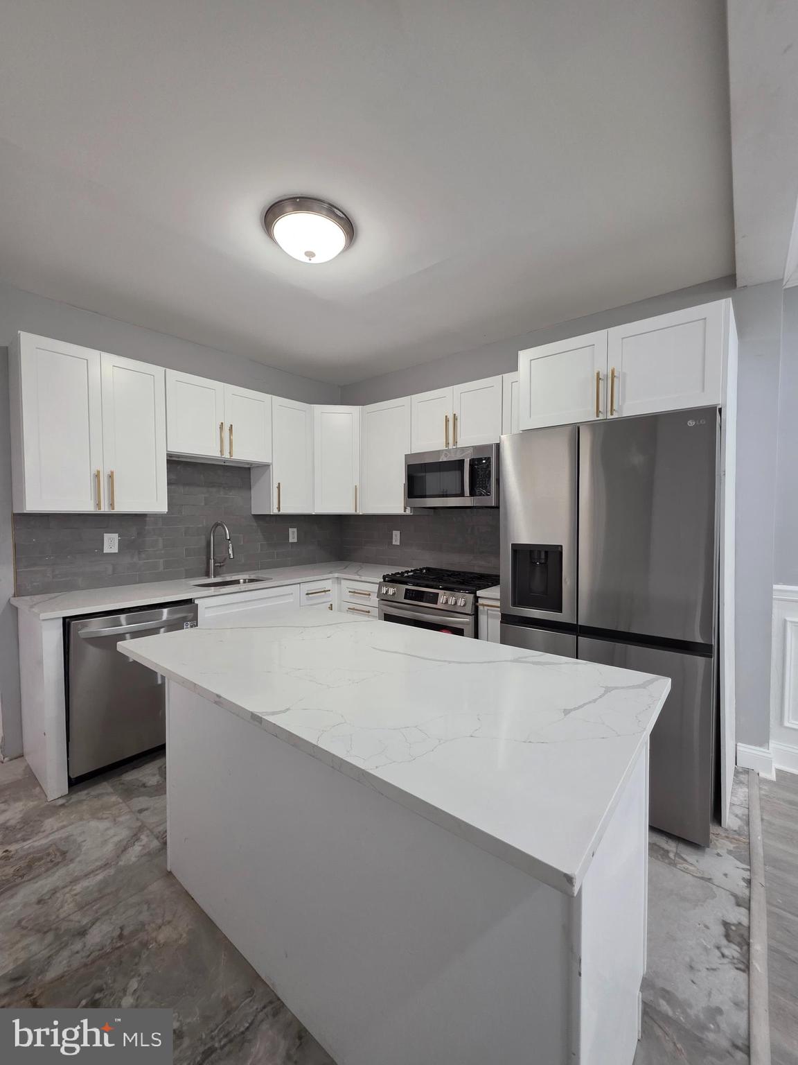 6026 Irving Street Philadelphia, PA 19139 - Photo 28 of 30 a kitchen with stainless steel appliances a refrigerator sink stove and oven