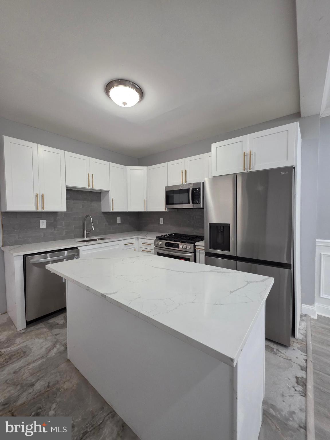 6026 Irving Street Philadelphia, PA 19139 - Photo 29 of 30 a kitchen with stainless steel appliances a refrigerator sink stove and oven