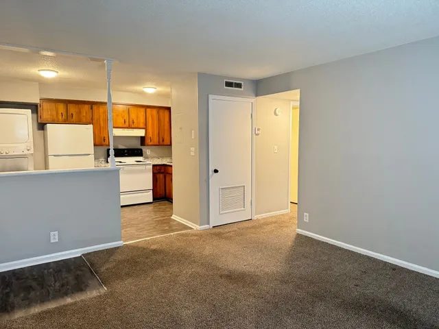 a view of a kitchen with a sink and a refrigerator