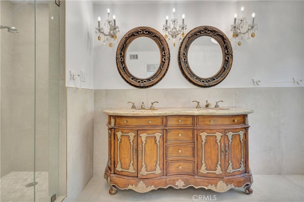 119 Bell Cyn Road Bell Canyon, CA 91307 - Photo 12 of 18 a bathroom with a granite countertop double vanity sink and a mirror