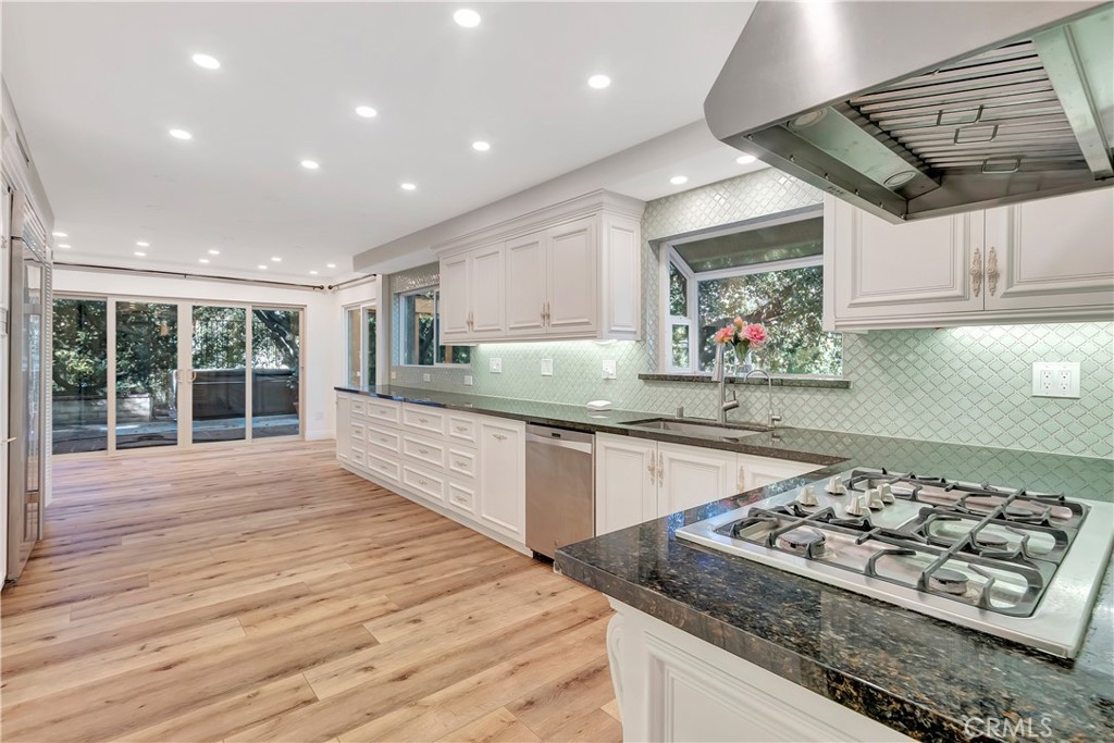 119 Bell Cyn Road Bell Canyon, CA 91307 - Photo 4 of 18 a kitchen with stainless steel appliances granite countertop a stove and a wooden cabinets