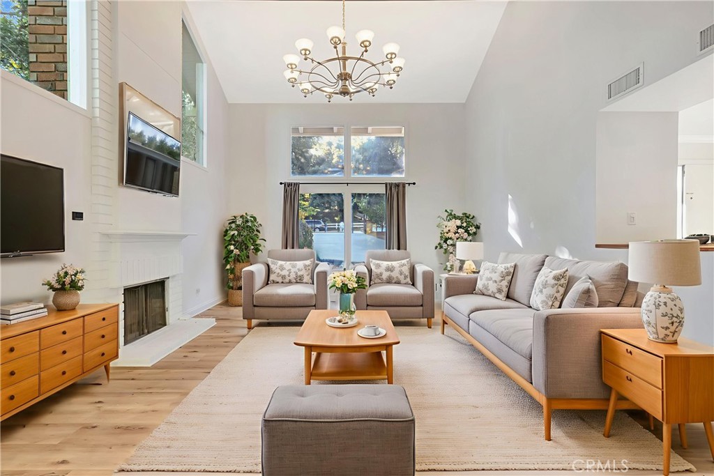 119 Bell Cyn Road Bell Canyon, CA 91307 - Photo 6 of 18 a living room with furniture a chandelier and a flat screen tv