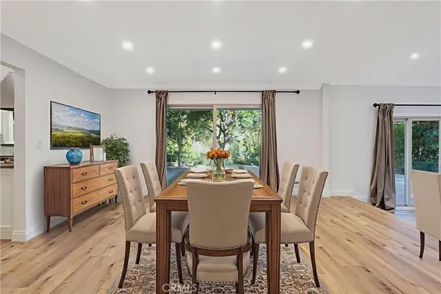 a dining room with furniture a rug and wooden floor