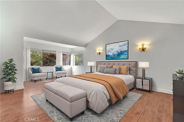 a bedroom with a large bed couch and a window