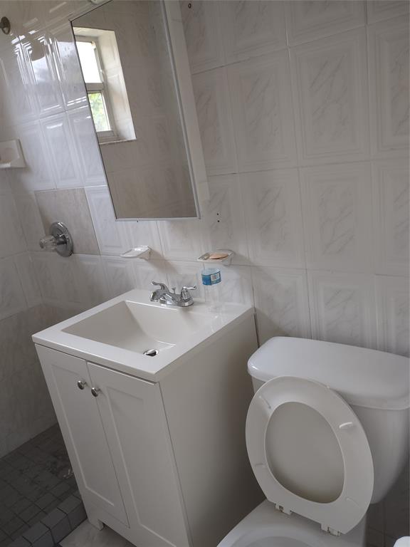 128 Miami Gardens Road West Park, FL 33023 - Photo 17 of 38 a white toilet sitting next to a white sink