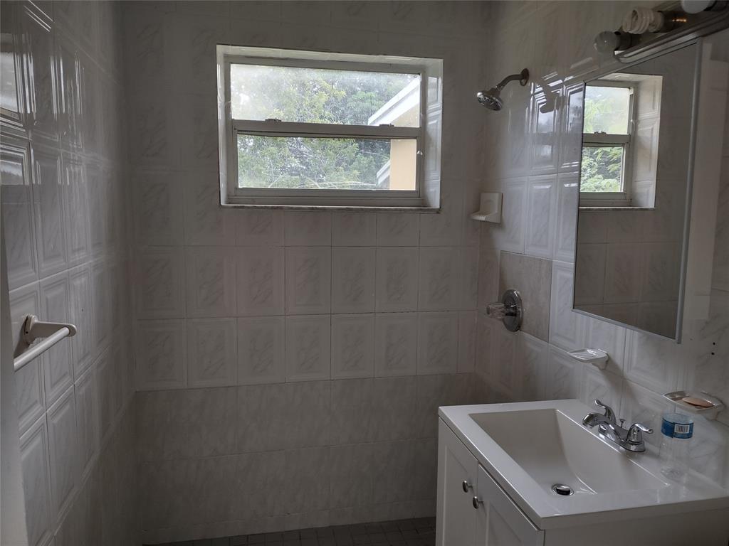 128 Miami Gardens Road West Park, FL 33023 - Photo 18 of 38 a bathroom with a sink a toilet and a window