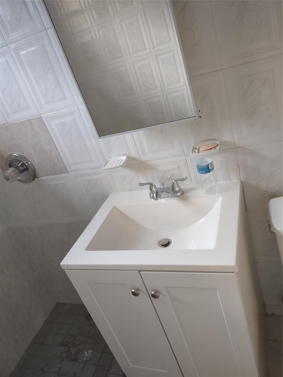 128 Miami Gardens Road West Park, FL 33023 - Photo 19 of 38 a bathroom with a sink and cabinets