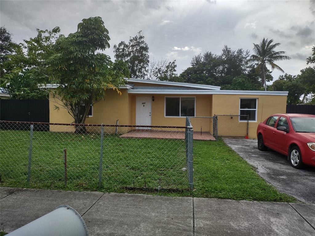 128 Miami Gardens Road West Park, FL 33023 - Photo 2 of 38 a front view of a house with garden