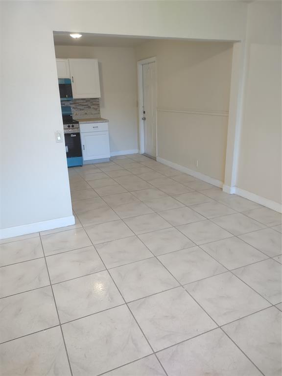 128 Miami Gardens Road West Park, FL 33023 - Photo 23 of 38 a view of a kitchen with an empty space and a sink cabinets