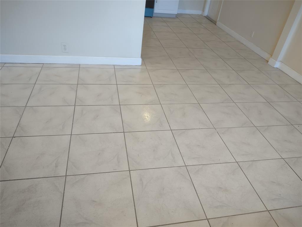 128 Miami Gardens Road West Park, FL 33023 - Photo 24 of 38 a view of a empty room with white tiles