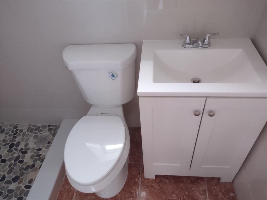 128 Miami Gardens Road West Park, FL 33023 - Photo 26 of 38 a bathroom with a sink and toilet