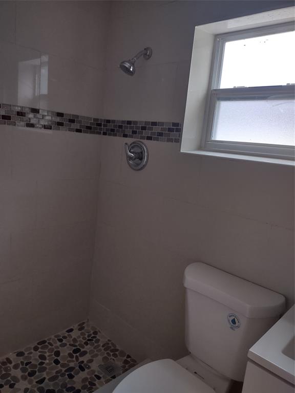 128 Miami Gardens Road West Park, FL 33023 - Photo 27 of 38 a bathroom with a toilet and a window